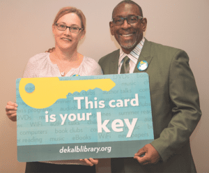 DeKalb Schools Superintendent R. Stephen Green and Library Director Alison Weissinger show off new, limited edition library card. 