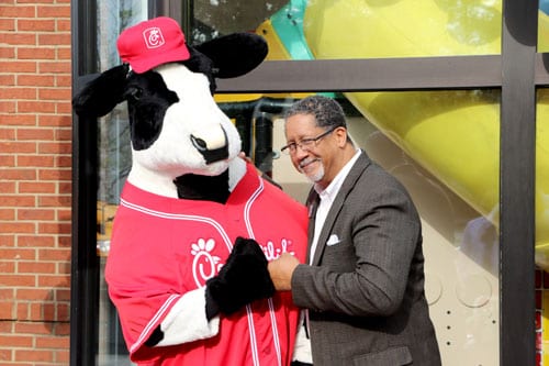 Stonecrest Mayor Jason Lary gives a fist bump to the Chick-fil-A cow