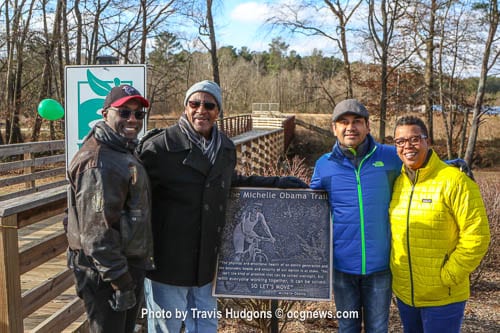 L-R: DeKalb County District 3 Commissioner Larry Johnson; DeKalb’s Department of Recreation, Parks and Cultural Affairs Interim Director Marvin F. Billups, Jr.; Vineet Nagarkar, project manager; and Revonda Cosby, greenspace manager stand by the newly unveiled plaque for the Michelle Obama Trail located at Georgia State University-Perimeter College on Clifton Springs Road in Decatur. Photos by Travis Hudgons