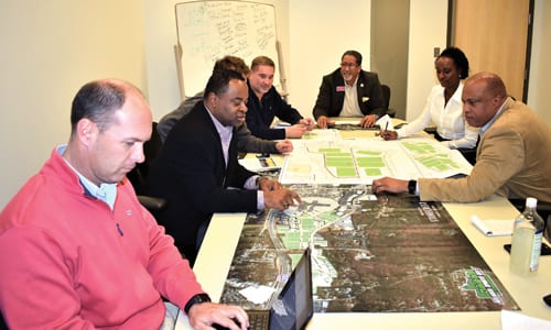 Bill Rowse (wearing red jacket), Vaughn Irons, Ray Bernabei, and Chris Daniluk discuss their site plans with Mayor Jason Lary, Economic Development Manager Sabrina Wright and Assistant City Manager Plez Joyner. Photo provided