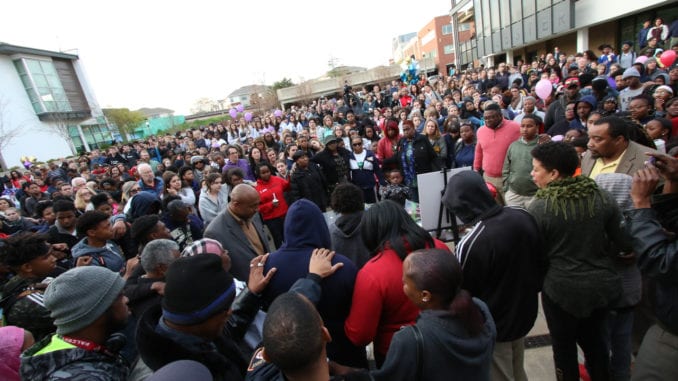 Hundreds of people laid hands on one another and prayed during the candlelight vigil at the Beacon Municipal Courtyard in downtown Decatur. Photos by Travis Hudgons/OCG News