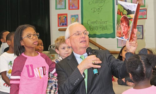 Georgia Commissioner of Agriculture Gary Black reads “Who Grew My Soup” to second graders at Shoal Creek Elementary STEAM Academy for Agriculture Literacy Day on March 22, 2018. Pictured, left to right: Veronica Ebanks, Colin Bailey, Commissioner Gary Black and students in Wendy Morrison’s class. Photo provided