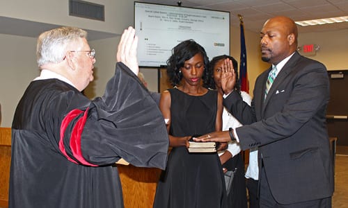 Rockdale County Public Schools Superintendent Dr. Terry Oatts–accompanied by his wife Yolanda, daughter Teryn, and son Landon–is sworn in by Rockdale County Superior Court Judge Robert Mumford. 