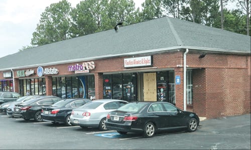 Anthony Jordan, 29, was gunned down in broad daylight on June 13 as he stood outside of the hair salon, which was boarded up after the shooting at the Citgo plaza, located ​​at the intersection of Redan and Panola roads. Photos by Travis Hudgons