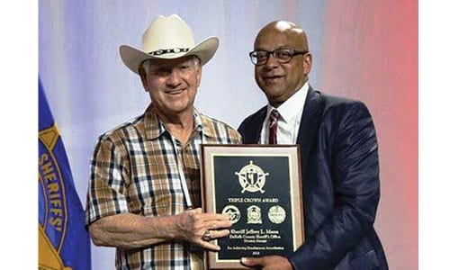 DeKalb County Sheriff Jeffrey L. Mann, accepts a second Triple Crown Award for law enforcement accreditations from National Sheriffs’ Association President Sheriff Harold Eavenson at the NSA Conference in New Orleans. 