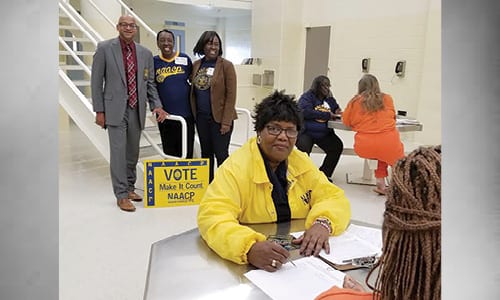 Standing: Sheriff Mann, DeKalb NAACP Political Action Chair Vivian Moore, and DeKalb NAACP President Teresa Hardy. Seated back: DeKalb NAACP Executive Member Louise Thompson with a new voter.  Seated, foreground:  Georgia State NAACP President Phyllis Blake and a new vote.