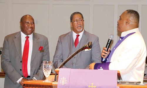 Pastor Edward. L. Randolph, Jr. of Union First Missionary Baptist Church, far right, performs the ordination of  Deacon Mayor Jason Lary, center, and Deacon Reginald Veasley. Photo by Glenn L. Morgan